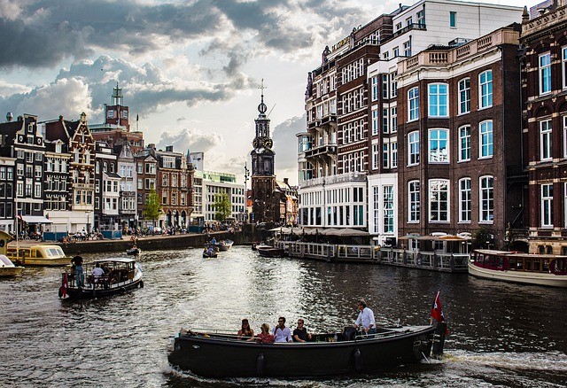 Attractions in Amsterdam include indulging in a canal trip.