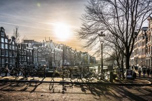 Attractions in Amsterdam include many canals and bicycles.